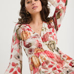 Woman wearing a floral dress with a white background