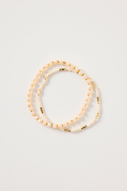 Cream and gold double beaded bracelet featuring mixed ivory beads and metallic gold accents, styled in a layered loop on a white background. Delicate women’s jewellery ideal for stacking, gifting and everyday wear.