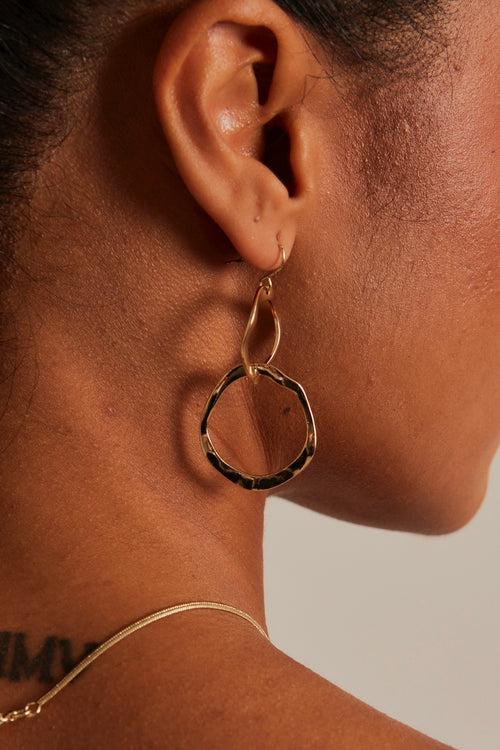 model wearing double link gold earrings