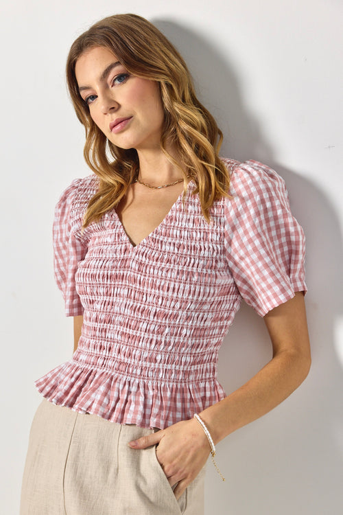 model wears pink gingham blouse