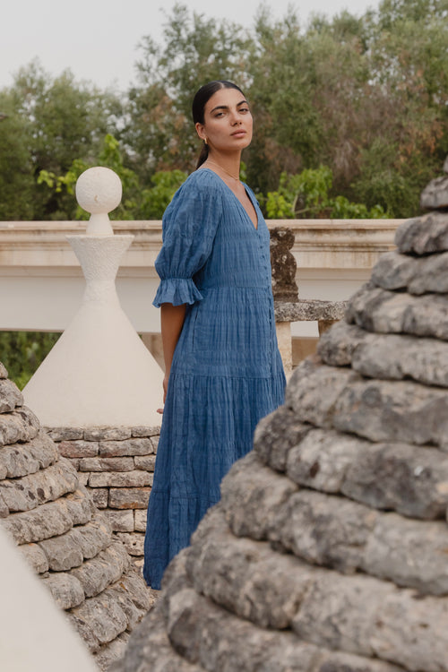 model wears a blue midi dress