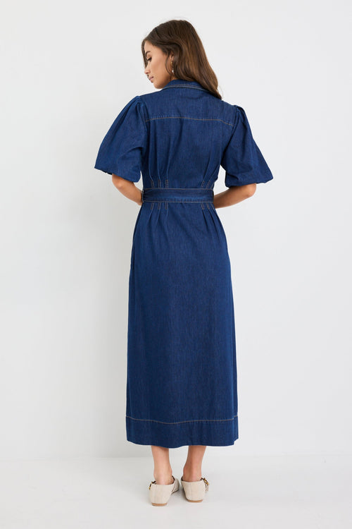 Woman wearing a blue dress on a white background