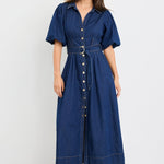 Woman wearing a blue dress with a belt on a white background