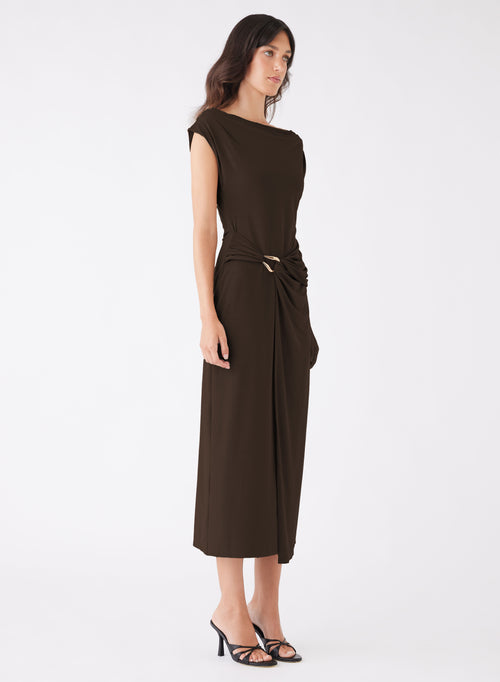 model wears a long brown dress