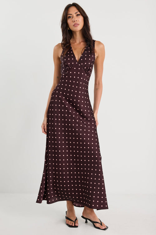 Woman wearing a patterned dress on a white background