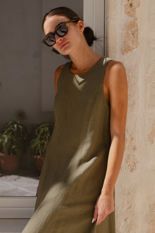 model wears a green maxi dress outside with sunglasses on