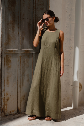 model wears a green maxi dress outside with sunglasses on