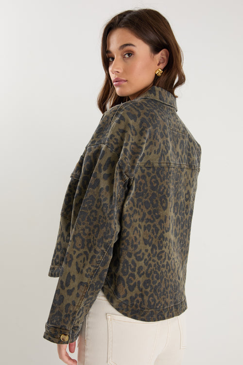 Woman wearing a leopard print jacket on a white background