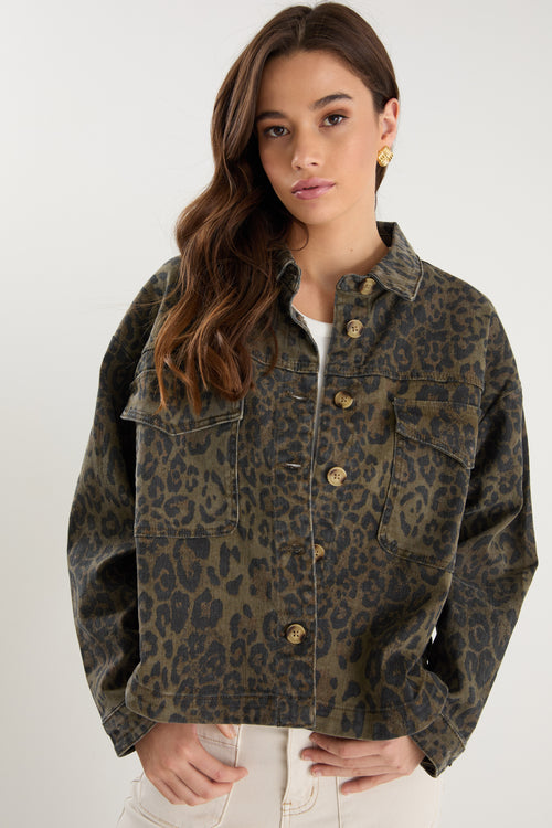 Woman wearing a leopard print jacket on a white background