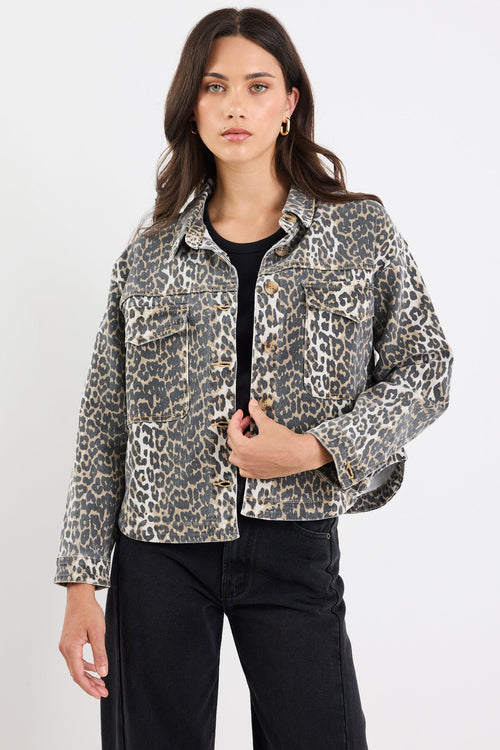 Woman wearing a leopard print jacket on a white background