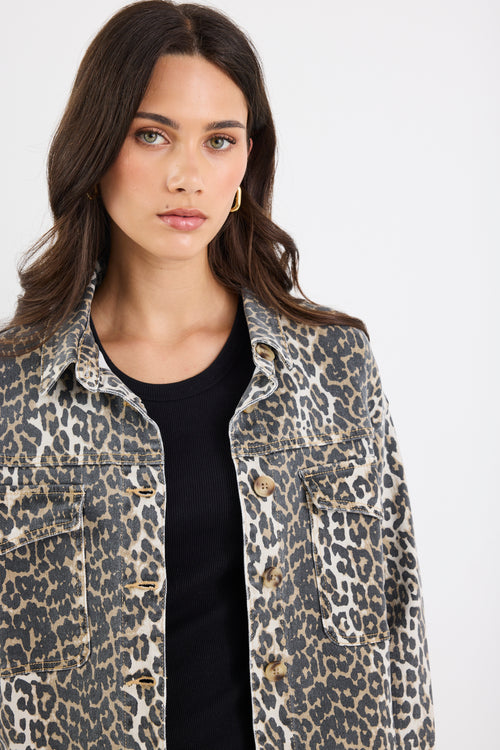 Woman wearing a leopard print jacket on a white background
