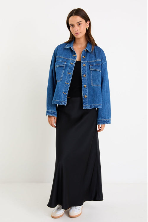 Model wearing a storm-blue denim jacket with patch pockets, button front and a relaxed fit.