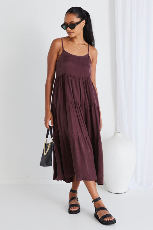 model wears a brown midi dress