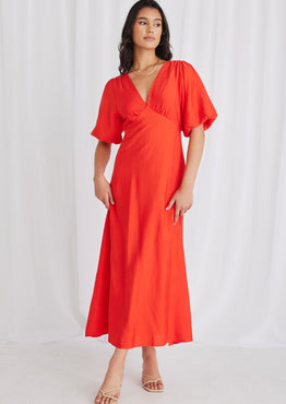 model wears a red maxi dress