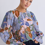 model wears a blue floral blouse