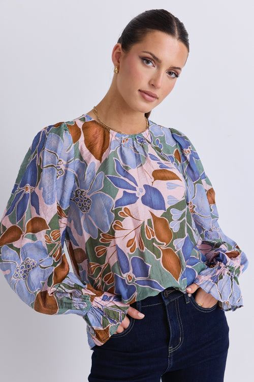 model wears a blue floral blouse