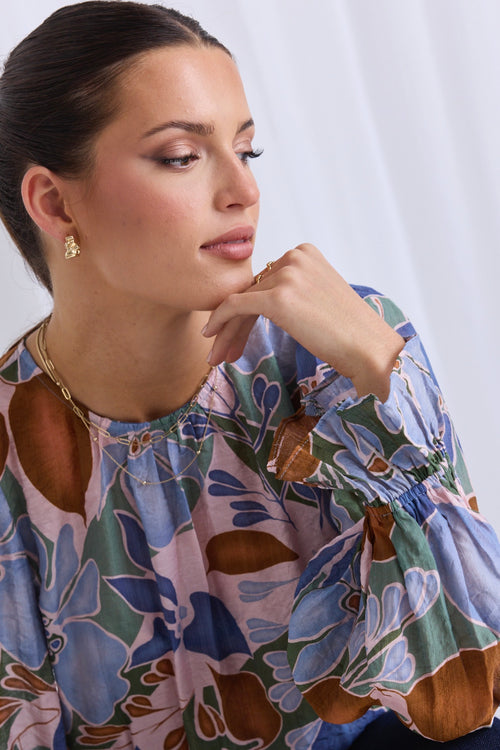 model wears a blue floral blouse