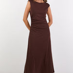 Woman wearing a brown dress on a white background