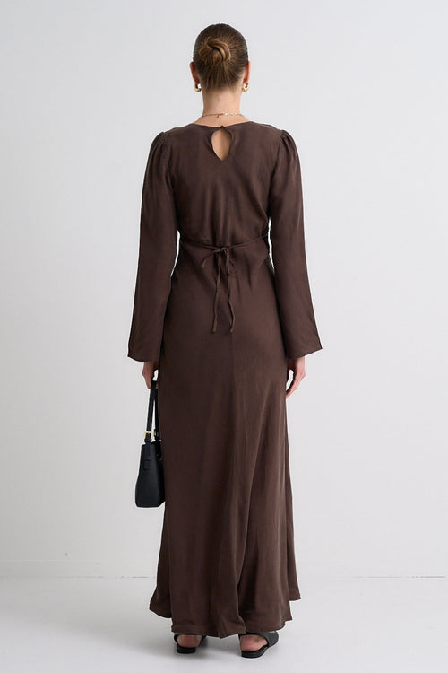 Model wears a brown maxi dress