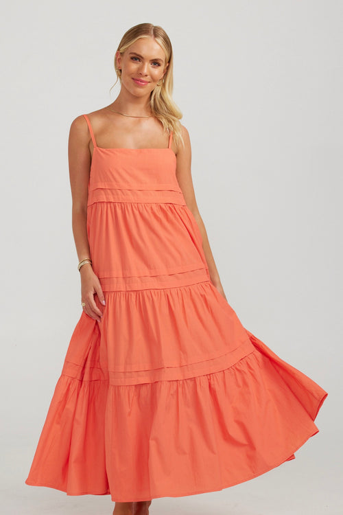 model wears a orange maxi dress