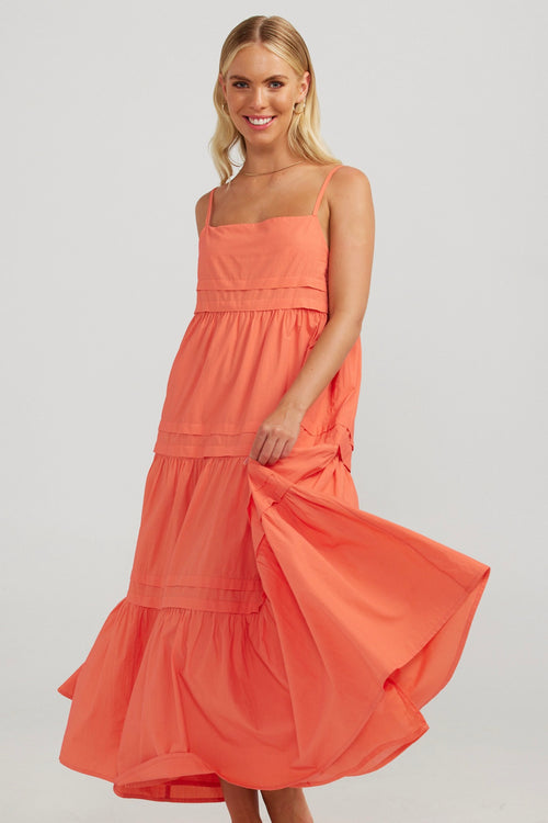 model wears a orange maxi dress