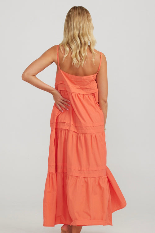 model wears a orange maxi dress