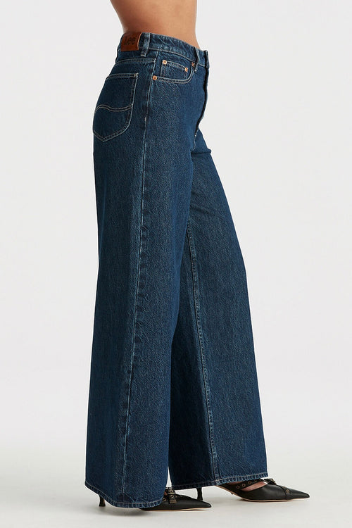 model wears blue wide leg jean