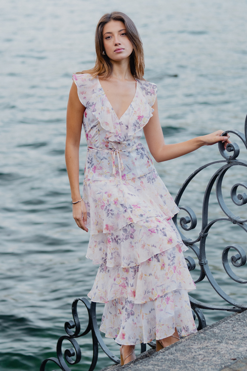 model wears a white floral maxi dress