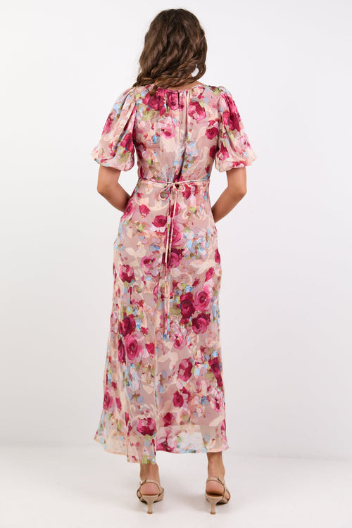 Woman wearing a floral dress from behind on a white background
