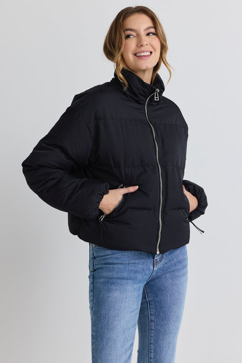 model wears a black puffer jacket