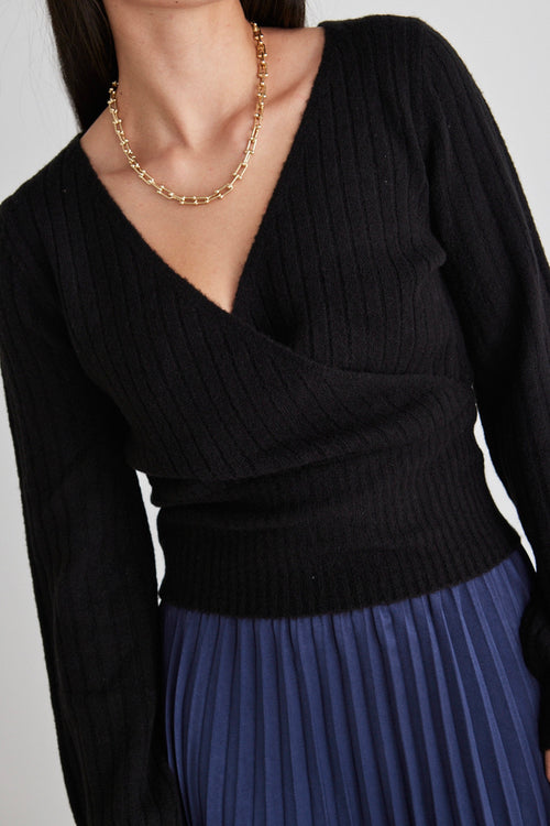Model wears a black wrap knit