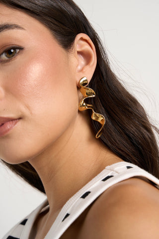 model wears gold earrings