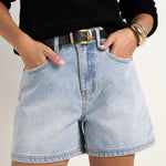 model wears blue denim shorts