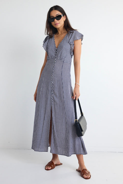 model wears a navy gingham midi dress