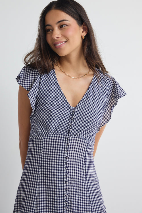 model wears a navy gingham midi dress