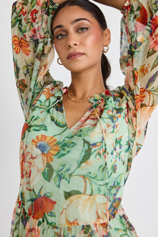 model wears a green floral dress