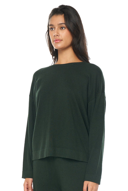 model wears a green knit