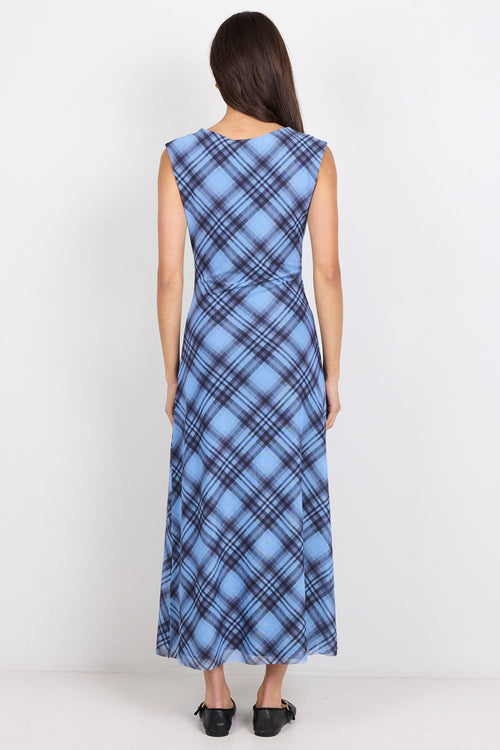 Woman wearing a blue plaid dress on a white background