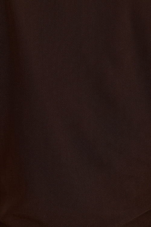 A close-up of dark brown textured fabric with a fine woven pattern and soft folds.