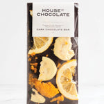 A packaged dark chocolate bar from House of Chocolate, featuring dried citrus slices and orange zest printed on the front of the wrapper, set against a clean white background.