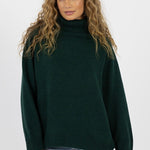 model wears a green knit jumper