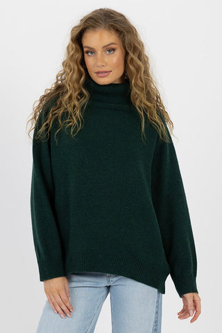 model wears a green knit jumper