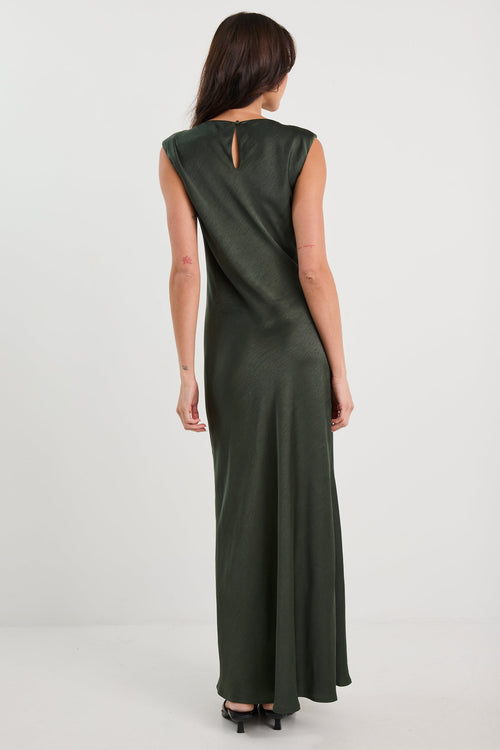 Woman wearing a green dress on a white background