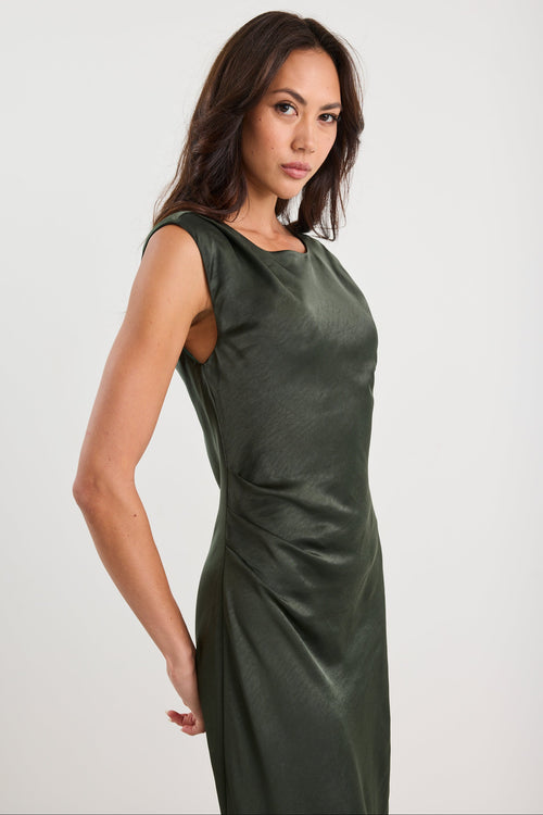 Woman wearing a green dress against a white background