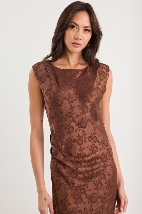 Woman wearing a brown lace dress against a white background
col_pattern