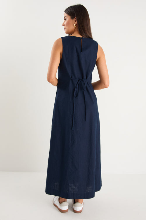 the model wears a navy and white stripe maxi dress with sneakers