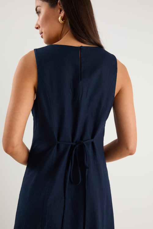 the model wears a navy and white stripe maxi dress with sneakers