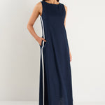 the model wears a navy and white stripe maxi dress with sneakers