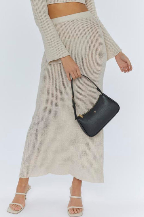 model with black leather handbag