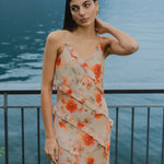 model wears orange ruffled slip dress